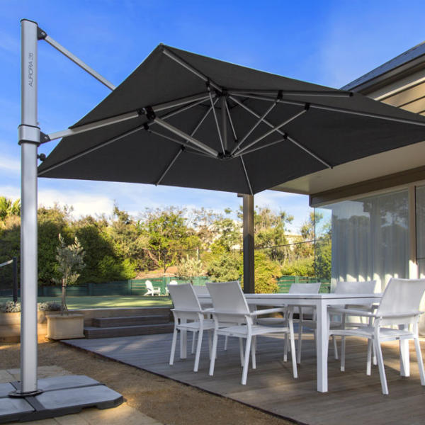 Grey umbrella giving shade to Geelong home outdoor eating area.