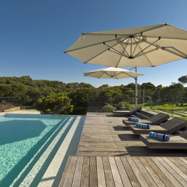 Two shade umbrellas poolside at Torquay home.