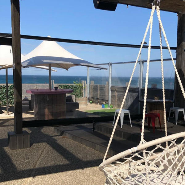 Alfresco screen on Torquay cafe with hammock in foreground.