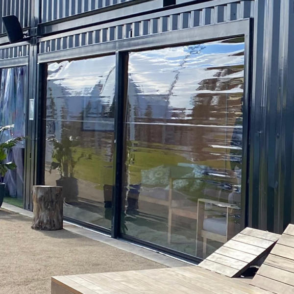 Alfresco screens covering large windows on corrugated building in Torquay.