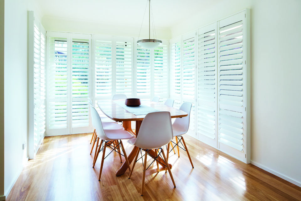 Dining room with white plantation shutters in Torquay.