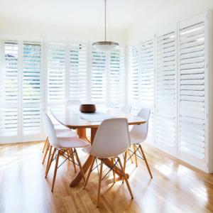 Light and airy dining room with white plantation shutters in Torquay.