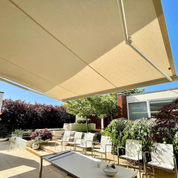 Large folding arm awnings giving shade to Torquay outdoor dining area.