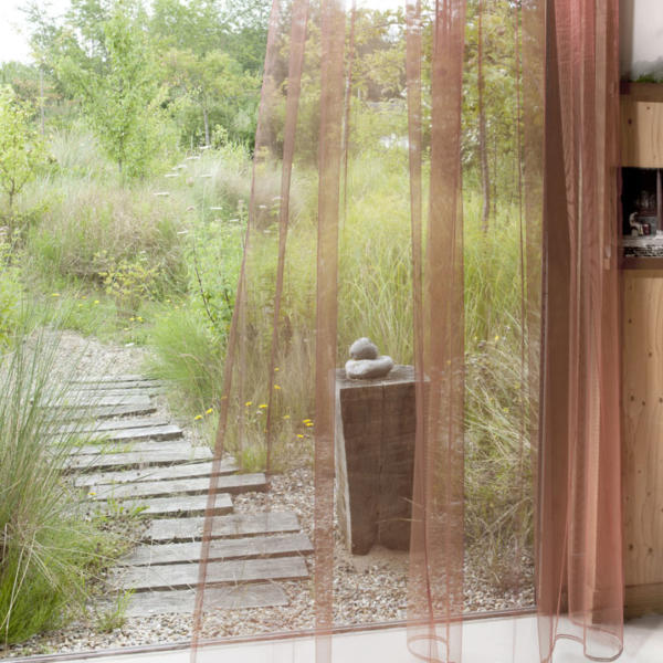 Sheer curtains in walkway overlooking wooden path in Torquay.