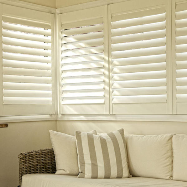 Corner of white lounge with plantation shutters in Geelong.