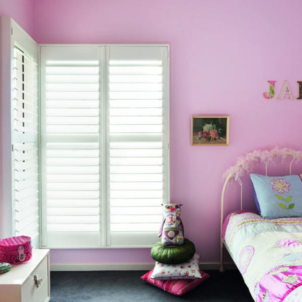 Bright pink bedroom with white plantation shutters in Geelong.