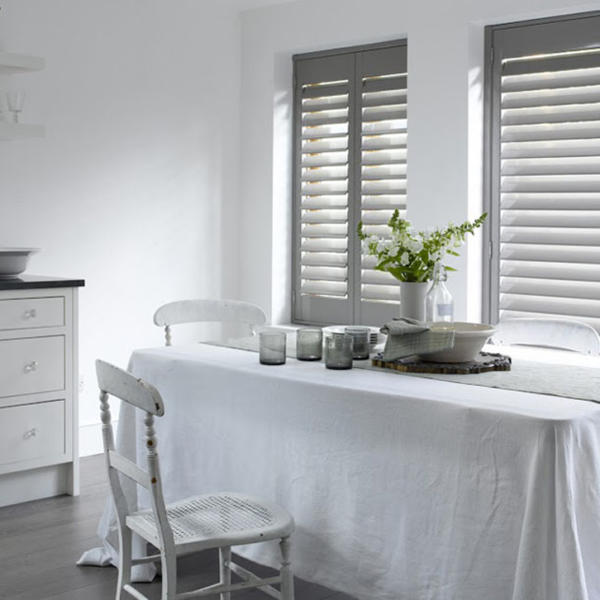 Kitchen with table setting in front of windows with plantation shutters in Geelong.