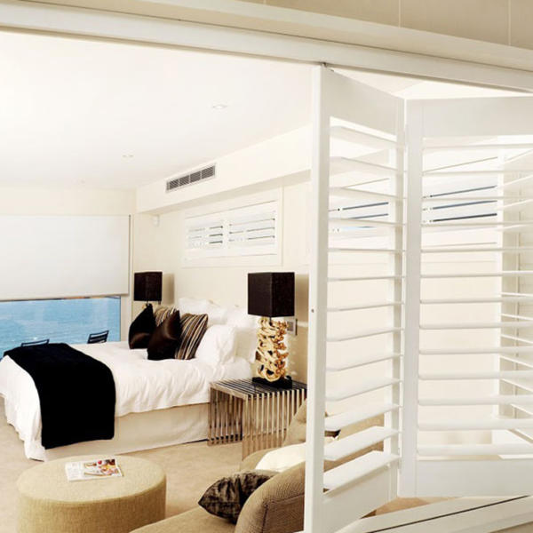 Bedroom window with white plantation shutters overlooking the ocean in Torquay.