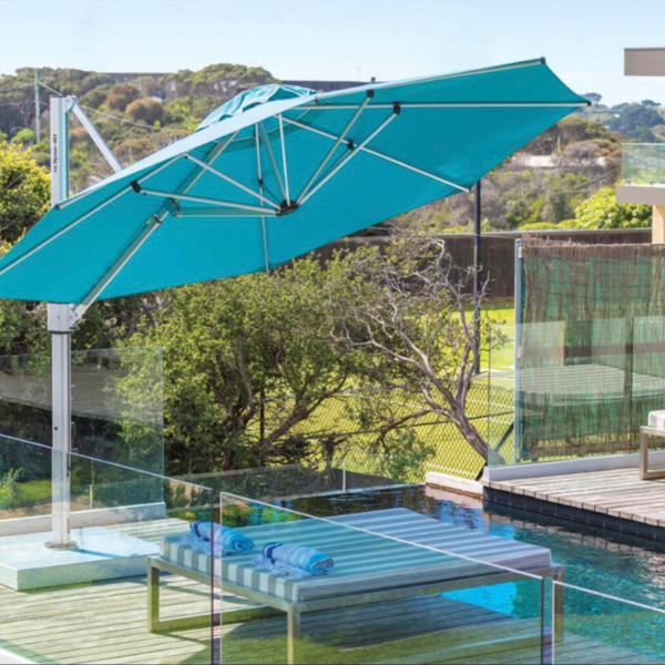 Large blue umbrella giving shade to a backyard pool in Torquay.