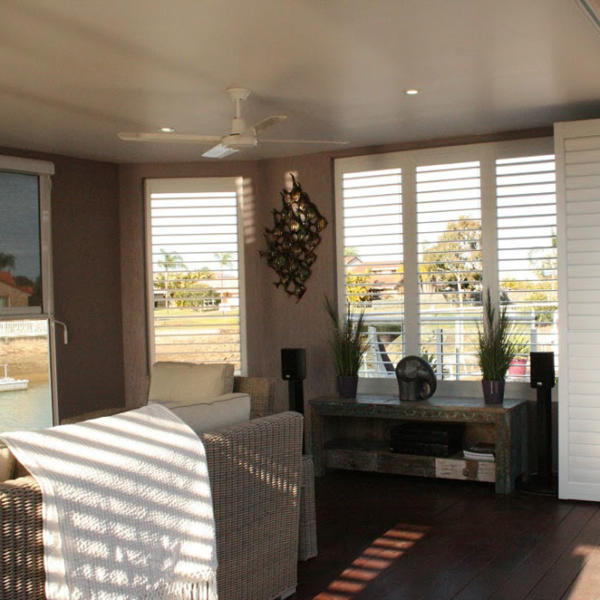 Windows with white aluminium plantation shutters on Torquay loungroom.